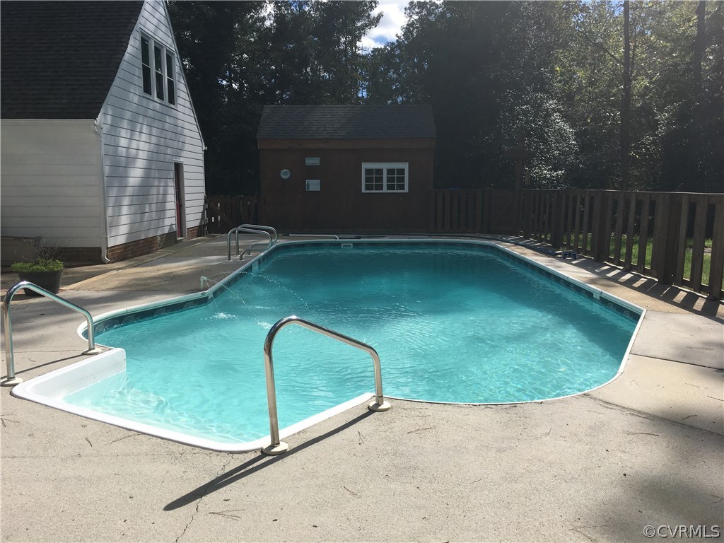12236 Riverway Road Chesterfield, VA 23838 - Photo 35 of 44 a view of a swimming pool with a bench in patio