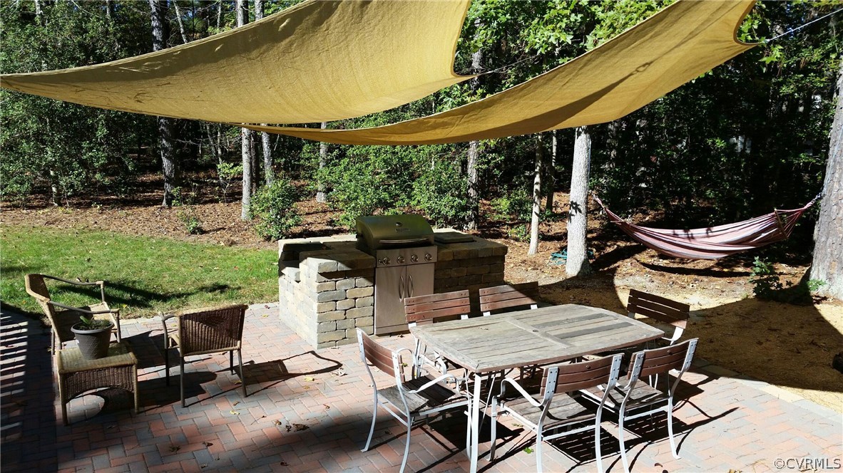 12236 Riverway Road Chesterfield, VA 23838 - Photo 39 of 44 a patio with yard glass top table and chairs