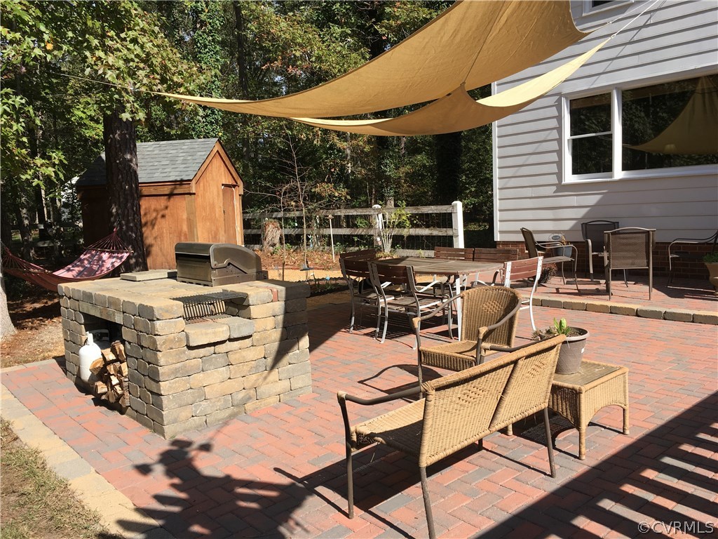 12236 Riverway Road Chesterfield, VA 23838 - Photo 40 of 44 a view of a patio with table and chairs with wooden floor and fence