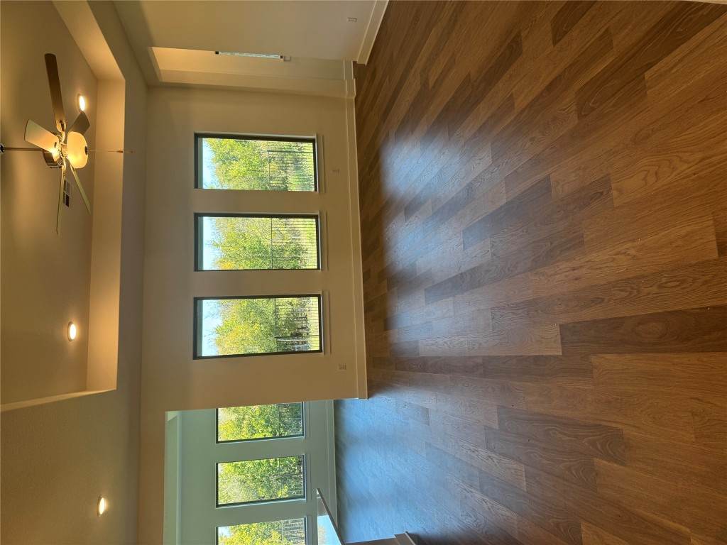 1828 Camay Street Leander, TX 78641 - Photo 4 of 15 a view of an empty room with wooden floor and a window
