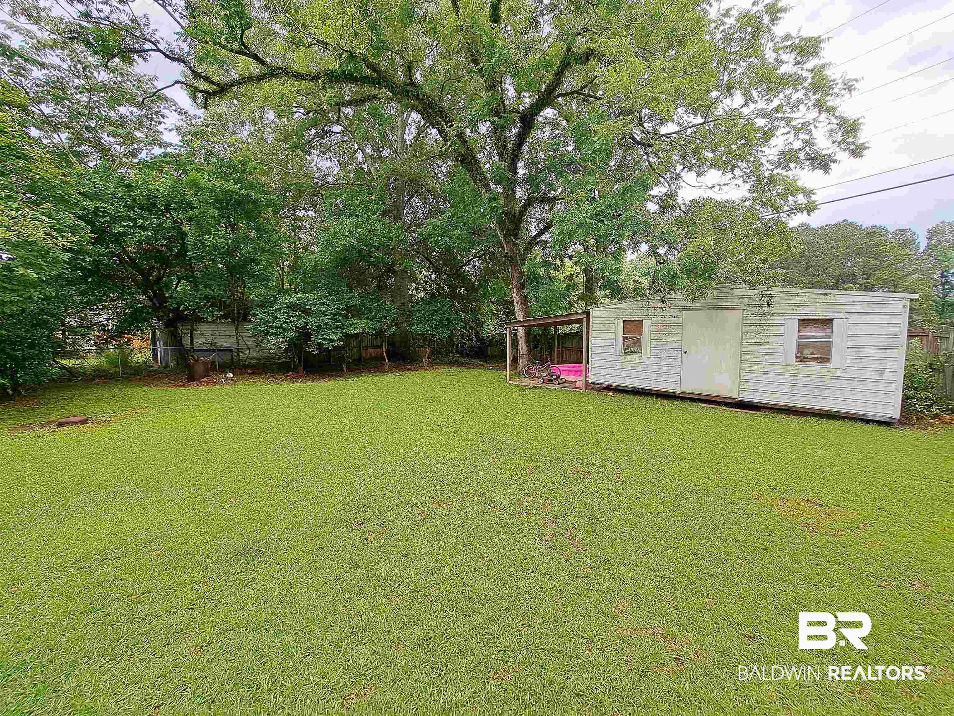 309 Bellview Avenue Evergreen, AL 36401 - Photo 27 of 27 View of yard featuring a storage unit and view of scattered trees