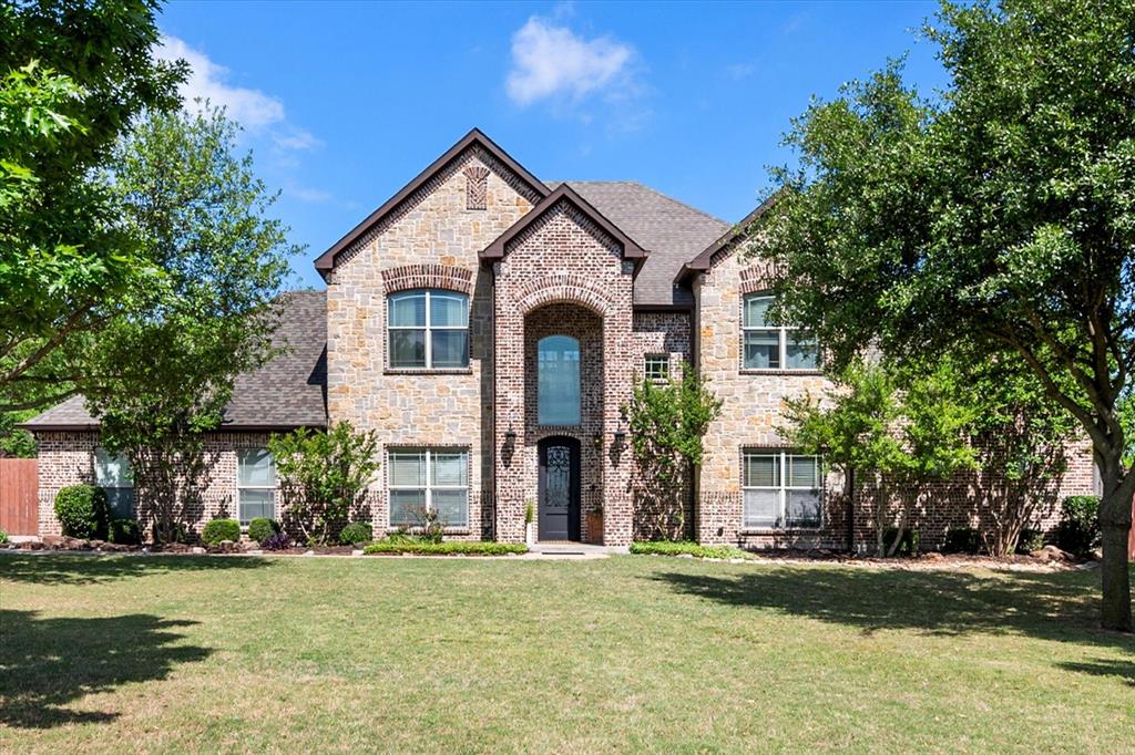 1634 Plum Creek Drive Midlothian, TX 76065 - Photo 1 of 35 View of front of house with brick siding, stone siding, a shingled roof, and a front lawn