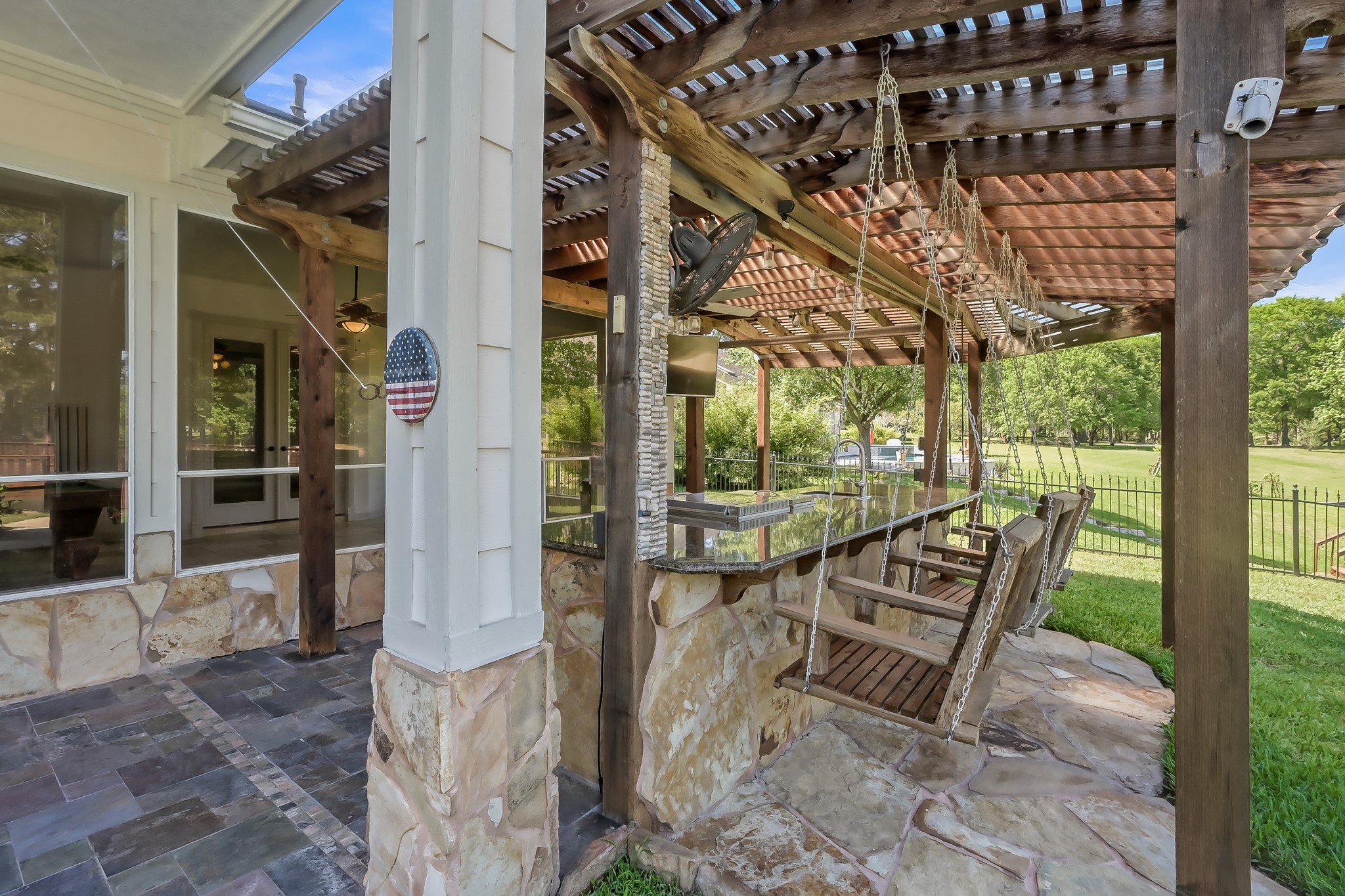 12758 Aries Loop Willis, TX 77318 - Photo 36 of 48 Swing seating along the Outdoor Kitchen Bar