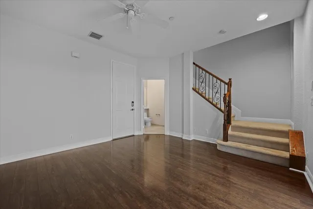a bathroom with a granite countertop sink mirror vanity and toilet