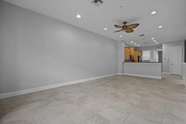 wooden floor in an empty room with a kitchen