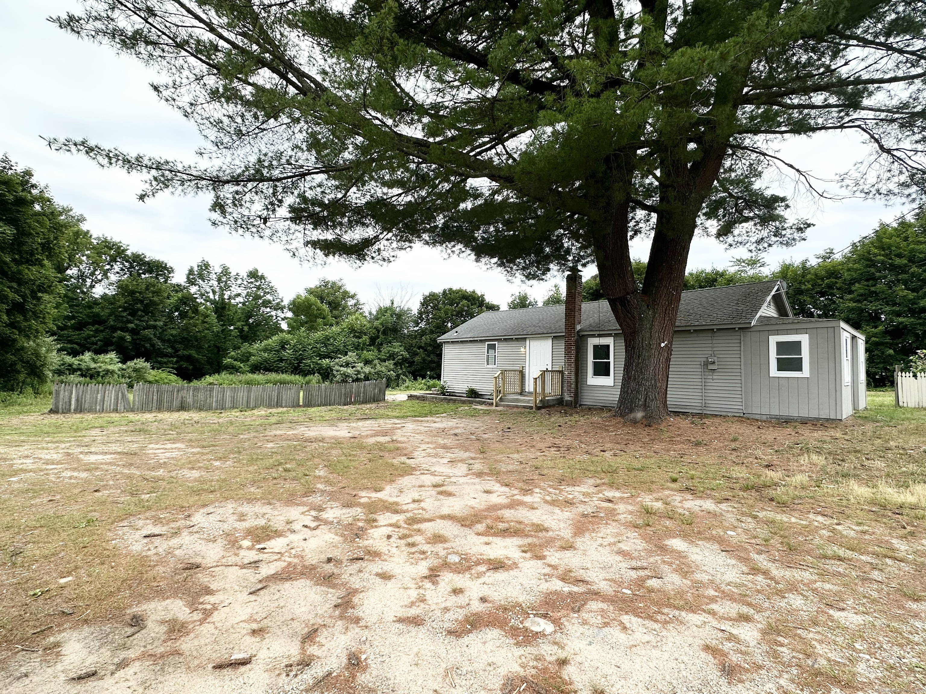 301 Brick Top Road Windham, CT 06280 - Photo 1 of 1 a house that has a tree in front of it