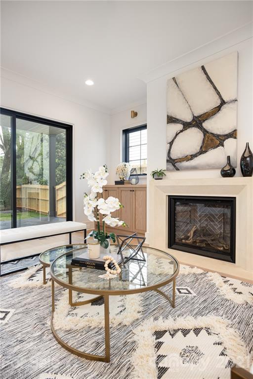 508 Westbury Road Charlotte, NC 28211 - Photo 20 of 48 a living room with furniture a fireplace and a floor to ceiling window