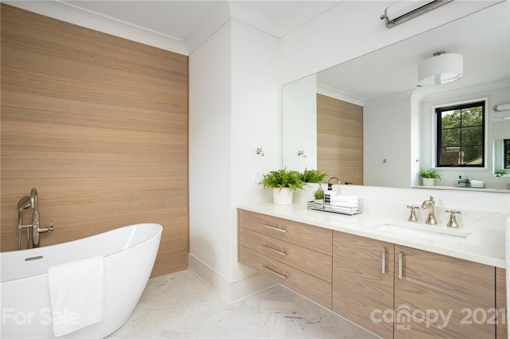 508 Westbury Road Charlotte, NC 28211 - Photo 23 of 48 a bathroom with a double vanity sink a mirror and a bathtub