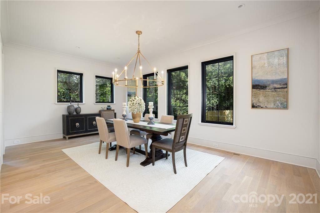 508 Westbury Road Charlotte, NC 28211 - Photo 40 of 48 a dining room with furniture a chandelier and wooden floor