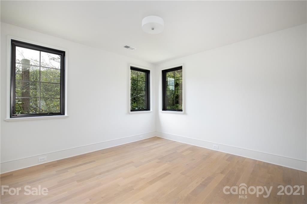 508 Westbury Road Charlotte, NC 28211 - Photo 41 of 48 an empty room with wooden floor and windows