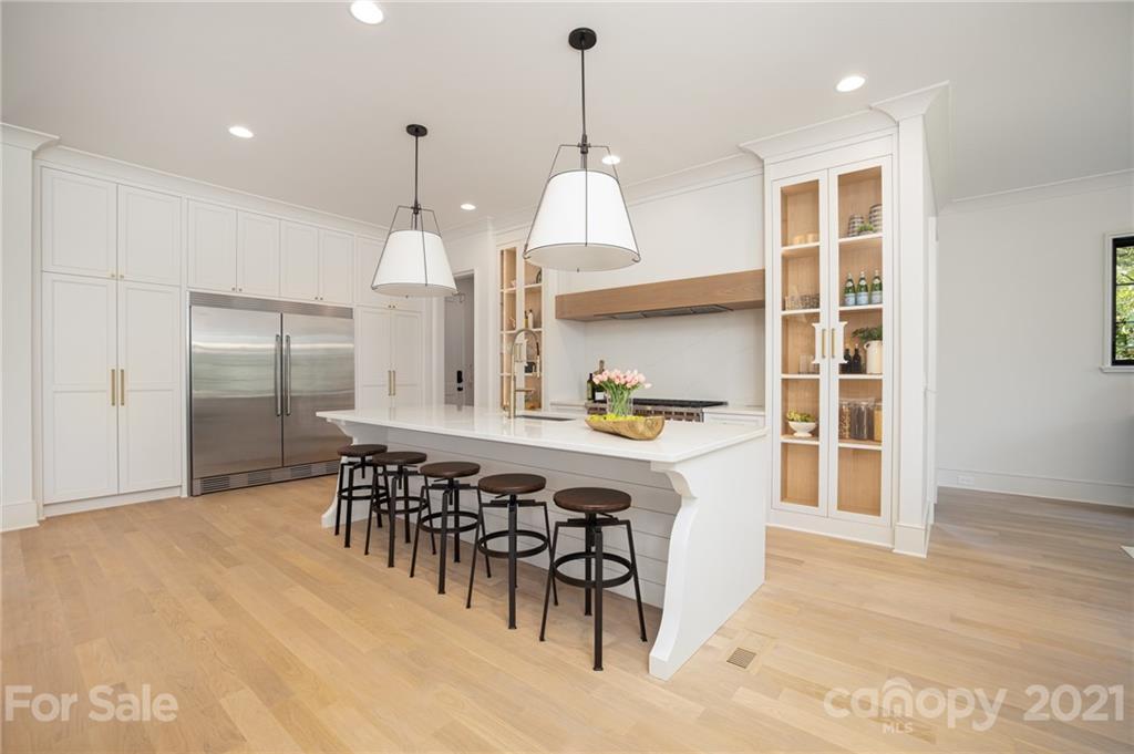 508 Westbury Road Charlotte, NC 28211 - Photo 46 of 48 a kitchen with granite countertop a center island a dining table and chairs