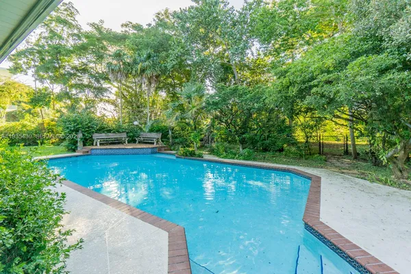 a view of a swimming pool with a yard