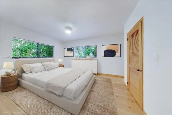 a room with a bed and a flat screen tv