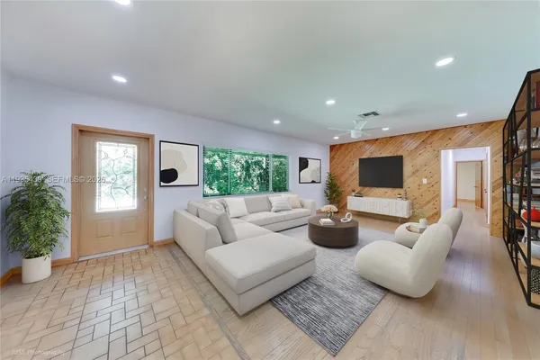 a living room with fireplace furniture and a potted plant