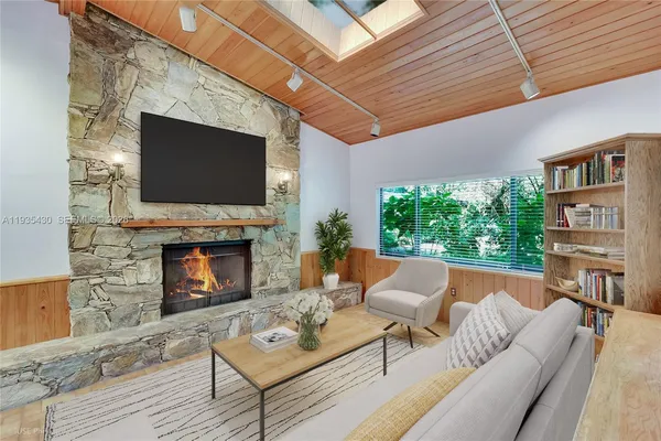 a living room with fireplace furniture and a flat screen tv