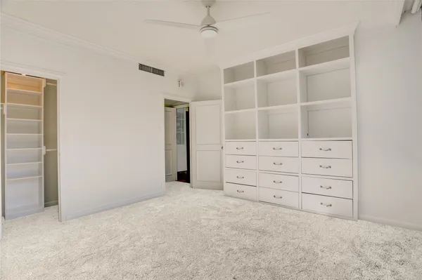 a view of an empty room with cabinet and space