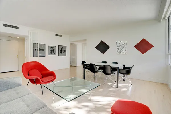 a room with two chairs and a chandelier