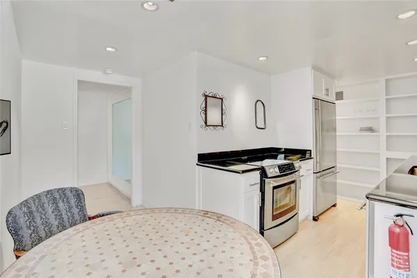a kitchen with stainless steel appliances granite countertop a stove and a refrigerator