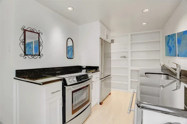a kitchen with stainless steel appliances granite countertop a stove and a sink