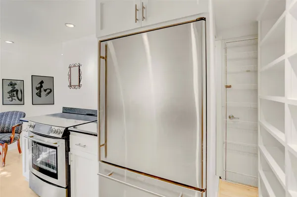 a kitchen with stainless steel appliances a refrigerator and a stove top oven