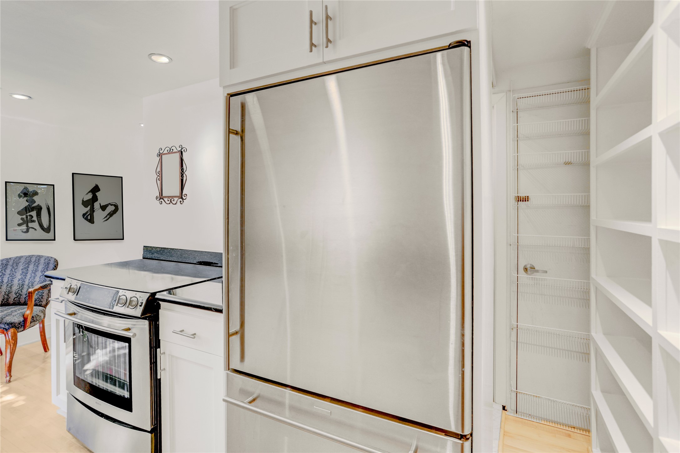 2701 Westheimer Road, Unit 2D Houston, TX 77098 - Photo 26 of 48 a kitchen with stainless steel appliances a refrigerator and a stove top oven