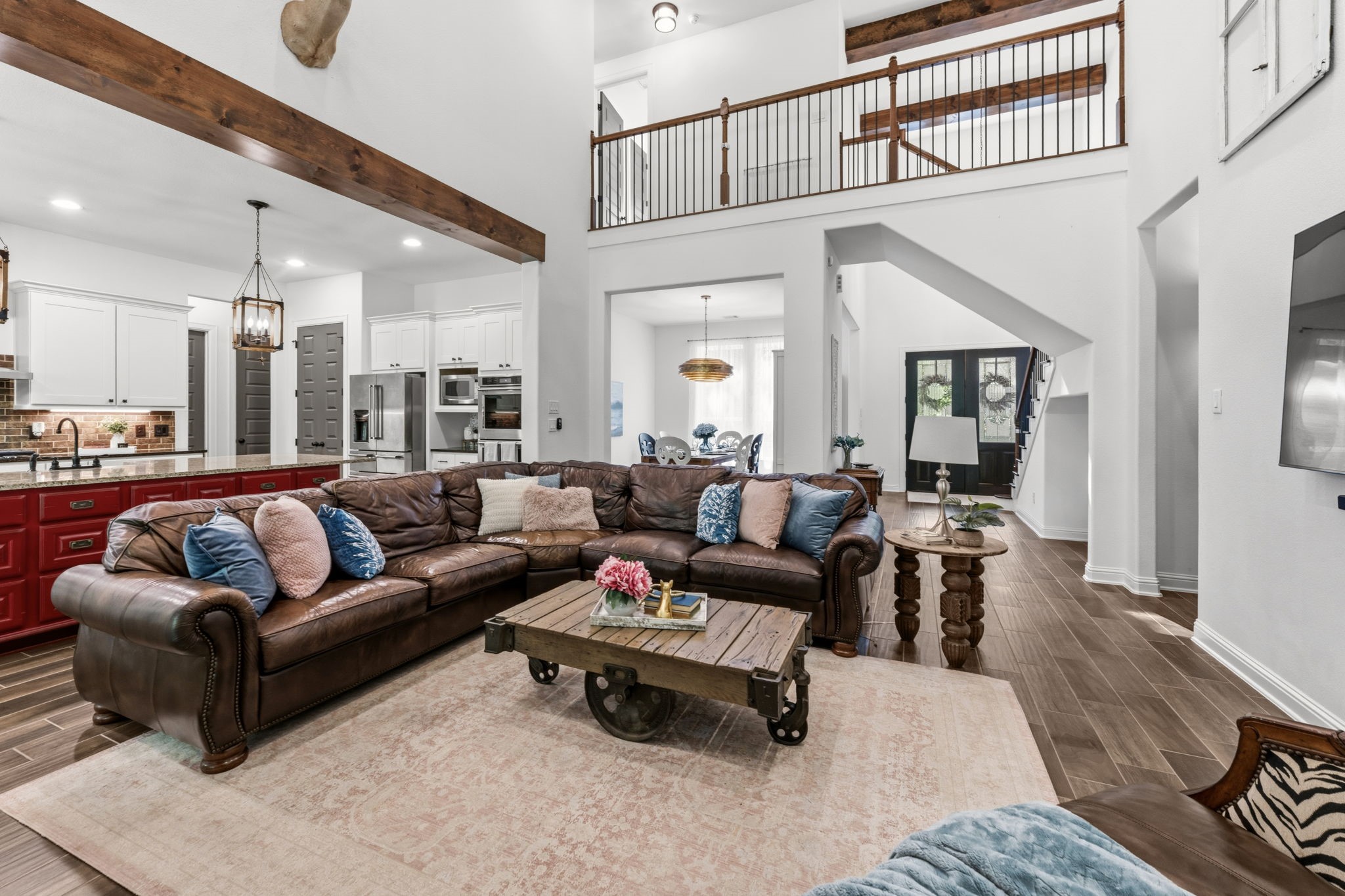 248 Fire Sky Road Huntsville, TX 77340 - Photo 9 of 36 Open-concept living at its best, with the family room flowing into the kitchen and offering views toward the dramatic entry, staircase and second-floor overlook.