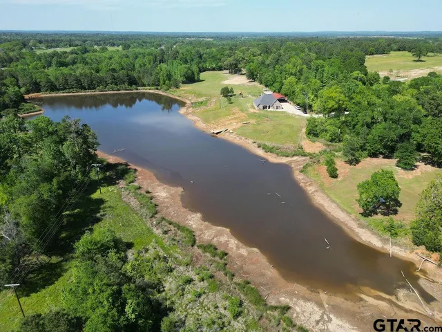 a living room with furniture a fireplace and a refrigerator
