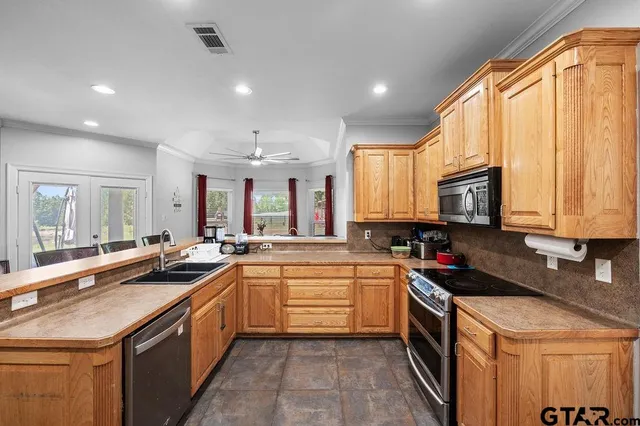 a kitchen with a refrigerator and a dining table