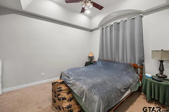 a bedroom with bed and a tv