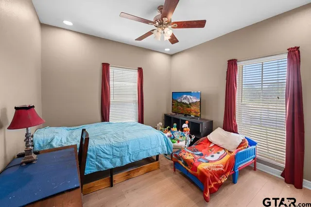 a bathroom with a double vanity sink toilet mirror and shower