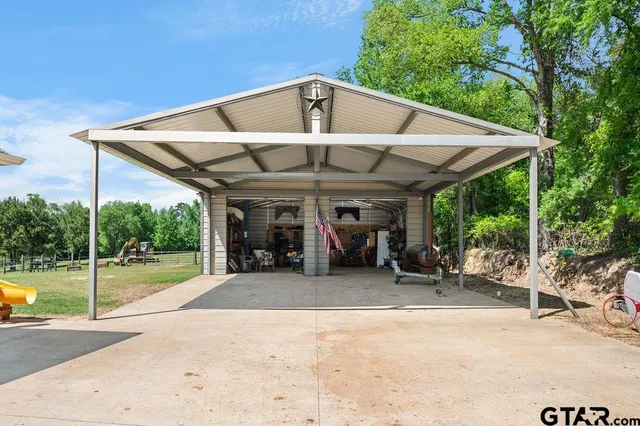 a view of a chairs and table in the patio with a small yard