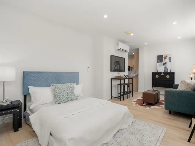 a kitchen with stainless steel appliances a stove a sink and a refrigerator