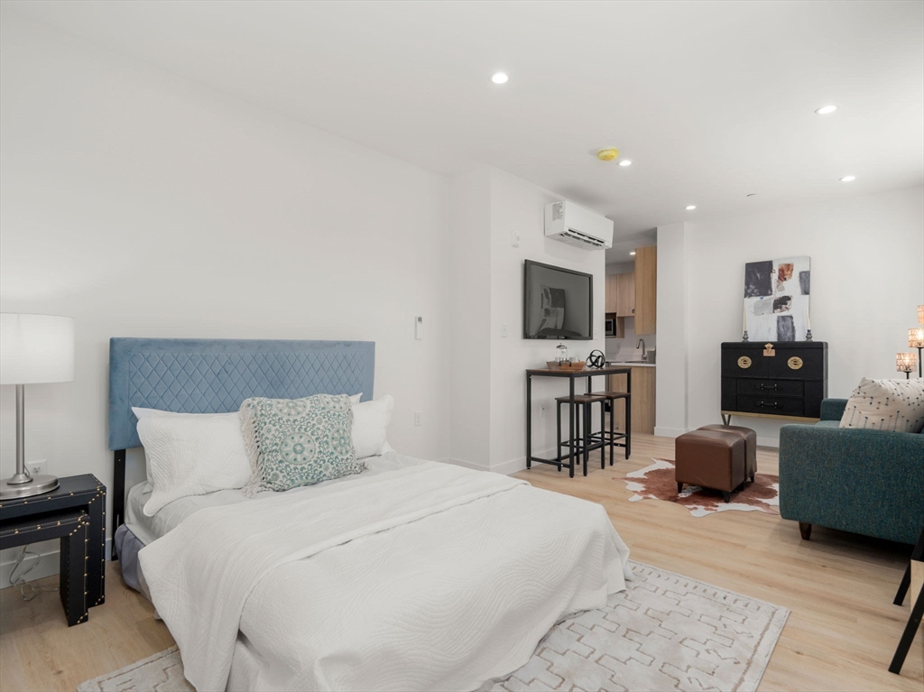 1151 Walnut Street, Unit 207 Newton, MA 02461 - Photo 6 of 27 a bedroom with a bed and furniture