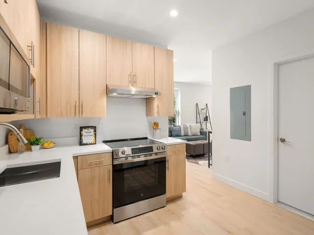 a kitchen with stainless steel appliances a refrigerator sink and microwave
