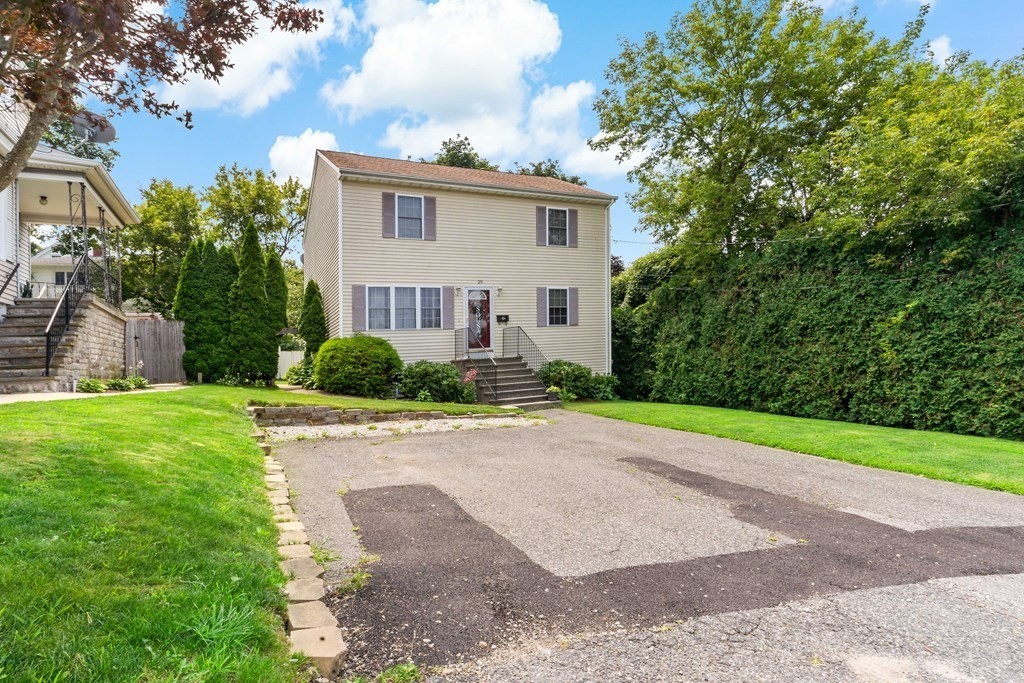 29 Florence Street Fall River, MA 02720 - Photo 34 of 34 a front view of a house with a yard and a garage