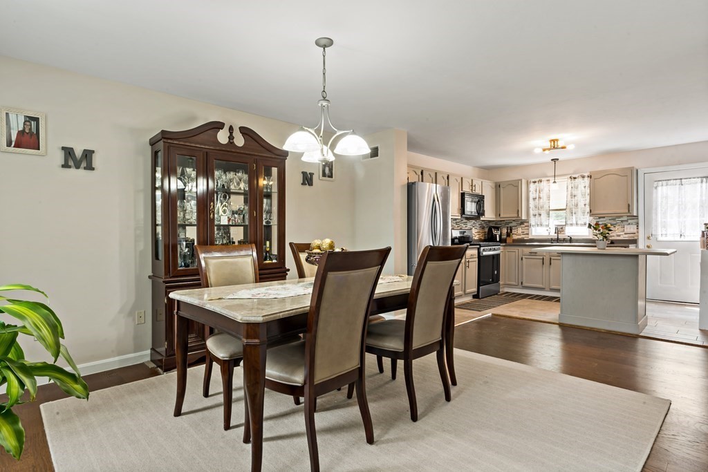 29 Florence Street Fall River, MA 02720 - Photo 4 of 34 a view of a dining room and livingroom with furniture wooden floor a chandelier