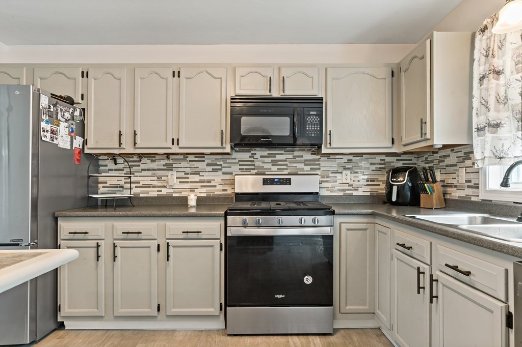 29 Florence Street Fall River, MA 02720 - Photo 7 of 34 a kitchen with cabinets stainless steel appliances and a sink
