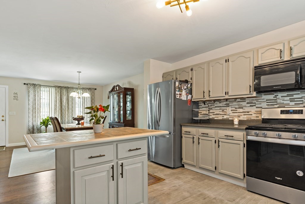 29 Florence Street Fall River, MA 02720 - Photo 8 of 34 a kitchen with stainless steel appliances a sink stove and cabinets