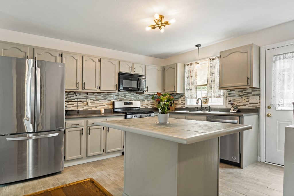 29 Florence Street Fall River, MA 02720 - Photo 9 of 34 a kitchen with appliances a sink and cabinets