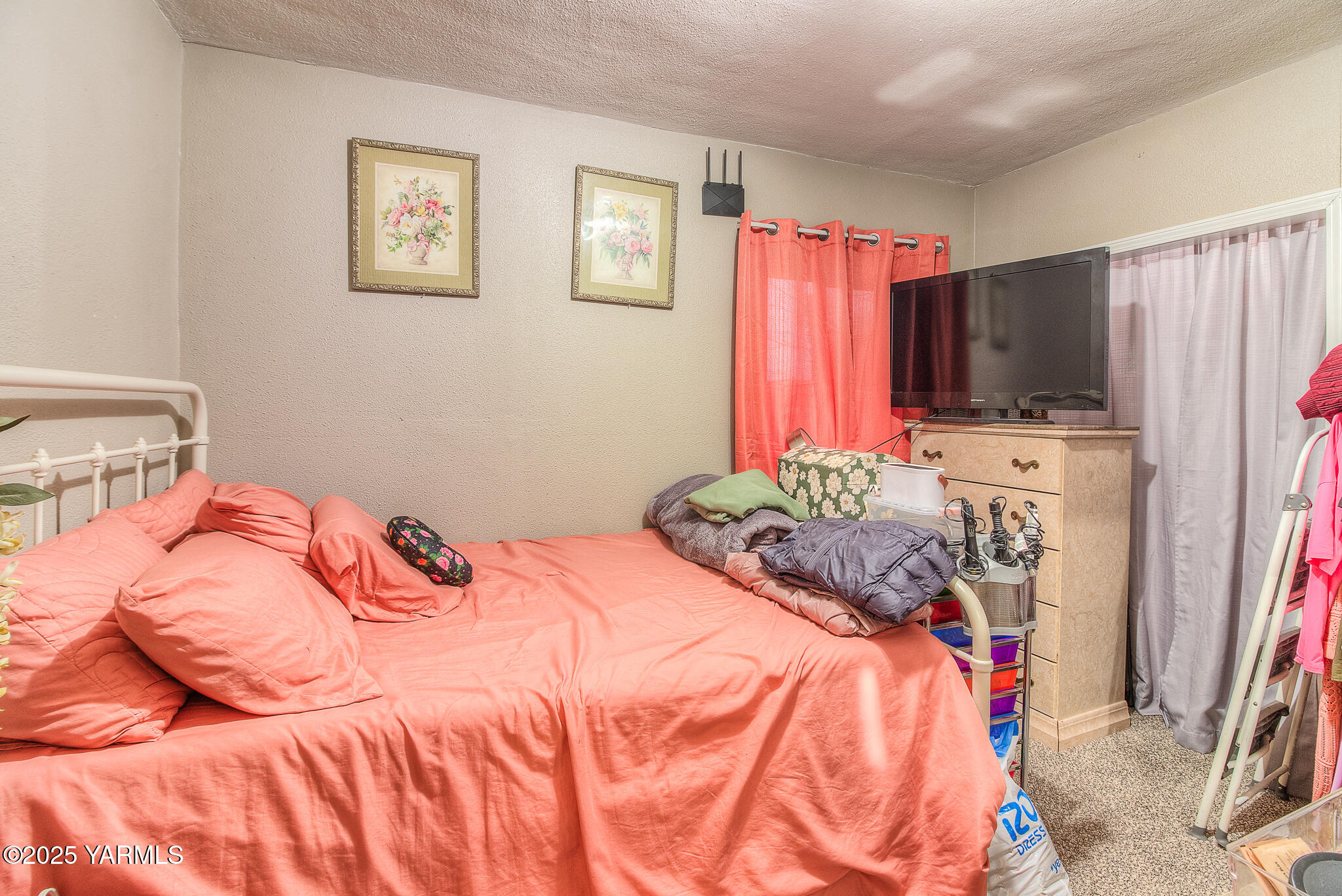 423 Wine Country Road Grandview, WA 98930 - Photo 9 of 14 a bedroom with a bed and a flat screen tv