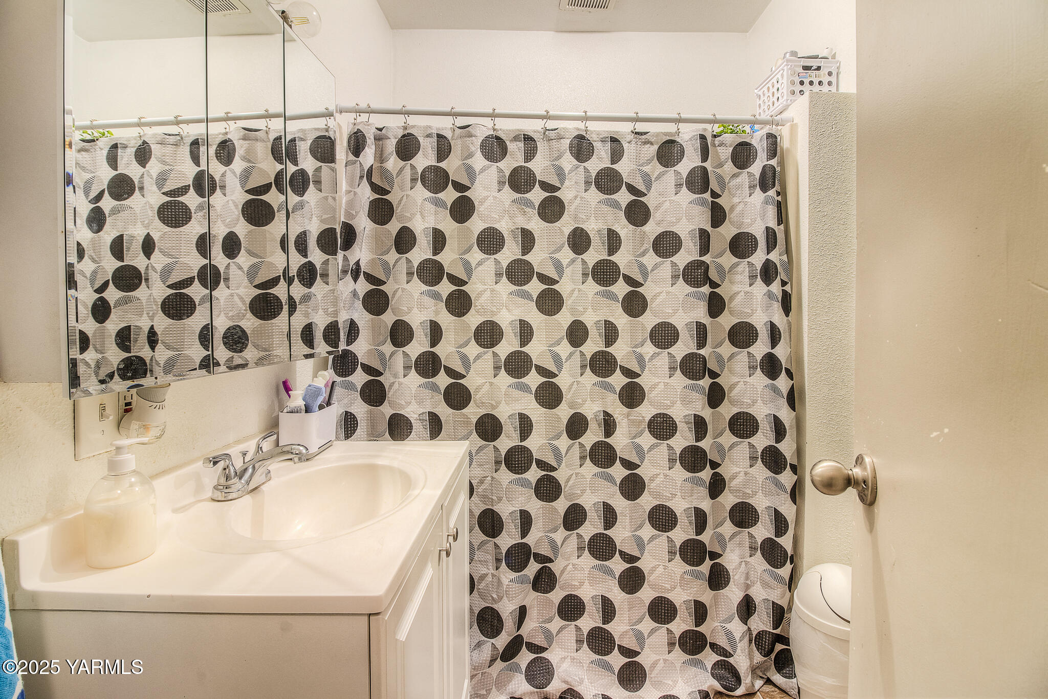 423 Wine Country Road Grandview, WA 98930 - Photo 10 of 14 a bathroom with a sink and a shower curtain
