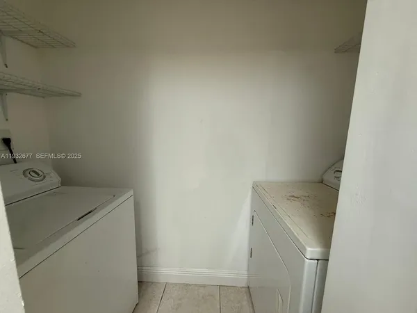 an empty room with white walls