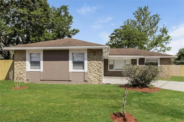 a front view of house with yard and outdoor seating