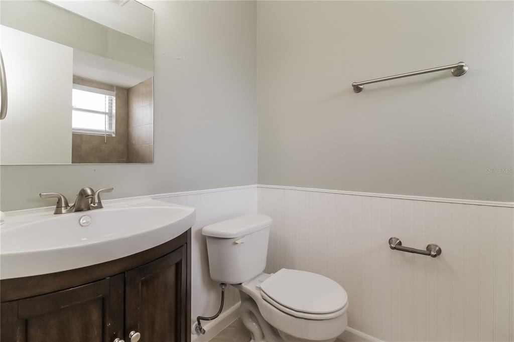 3014 Windchime Circle West Apopka, FL 32703 - Photo 14 of 16 a bathroom with a sink a toilet and vanity