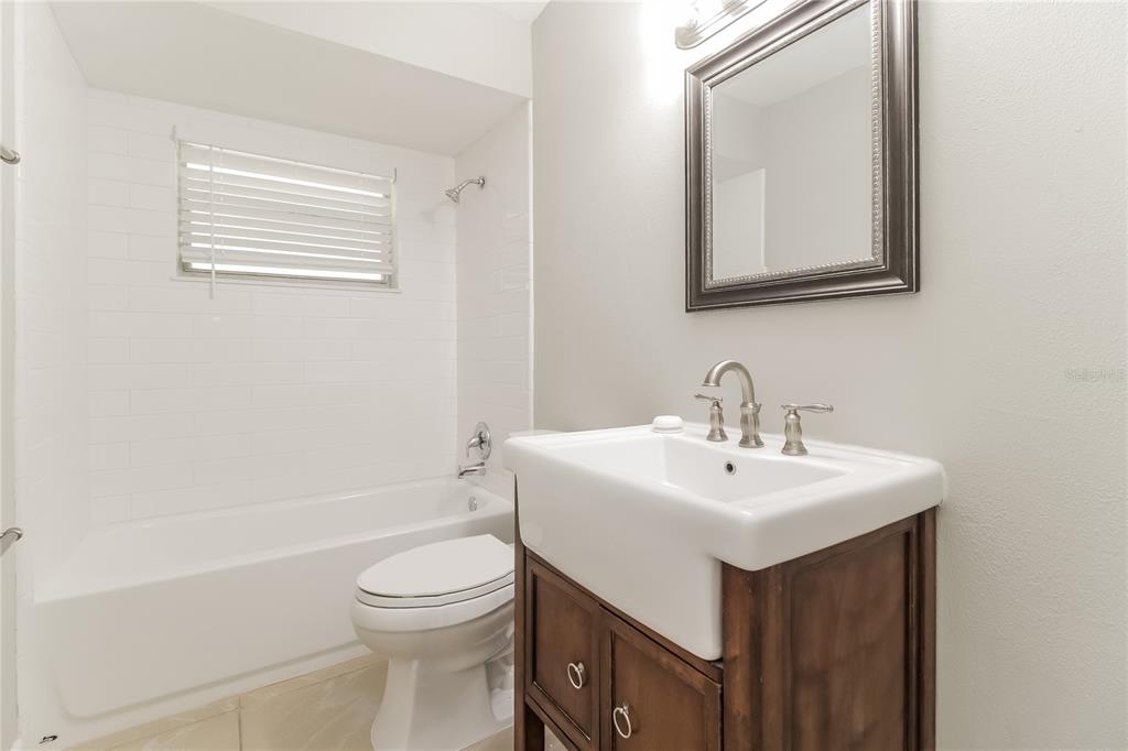 3014 Windchime Circle West Apopka, FL 32703 - Photo 8 of 16 a bathroom with a sink a toilet and shower