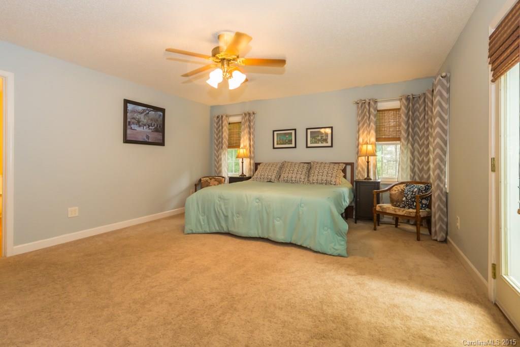 7218 Alexander Farm Road, Unit 3 B F Monroe, NC 28110 - Photo 13 of 24 a bedroom with a bed and a chandelier