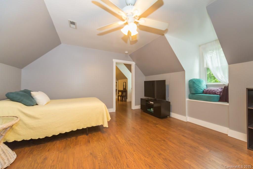 7218 Alexander Farm Road, Unit 3 B F Monroe, NC 28110 - Photo 16 of 24 a bedroom with a bed and a chandelier