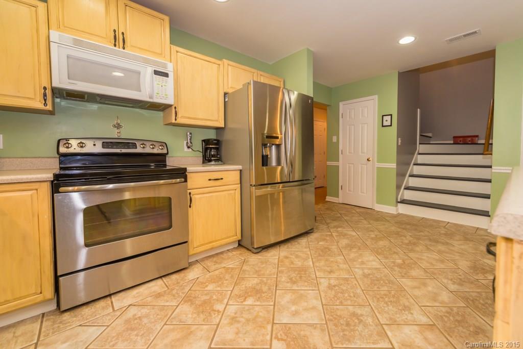 7218 Alexander Farm Road, Unit 3 B F Monroe, NC 28110 - Photo 9 of 24 a kitchen with a stove top oven and refrigerator