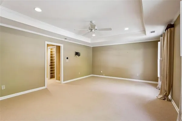 a view of walk in closet with empty racks