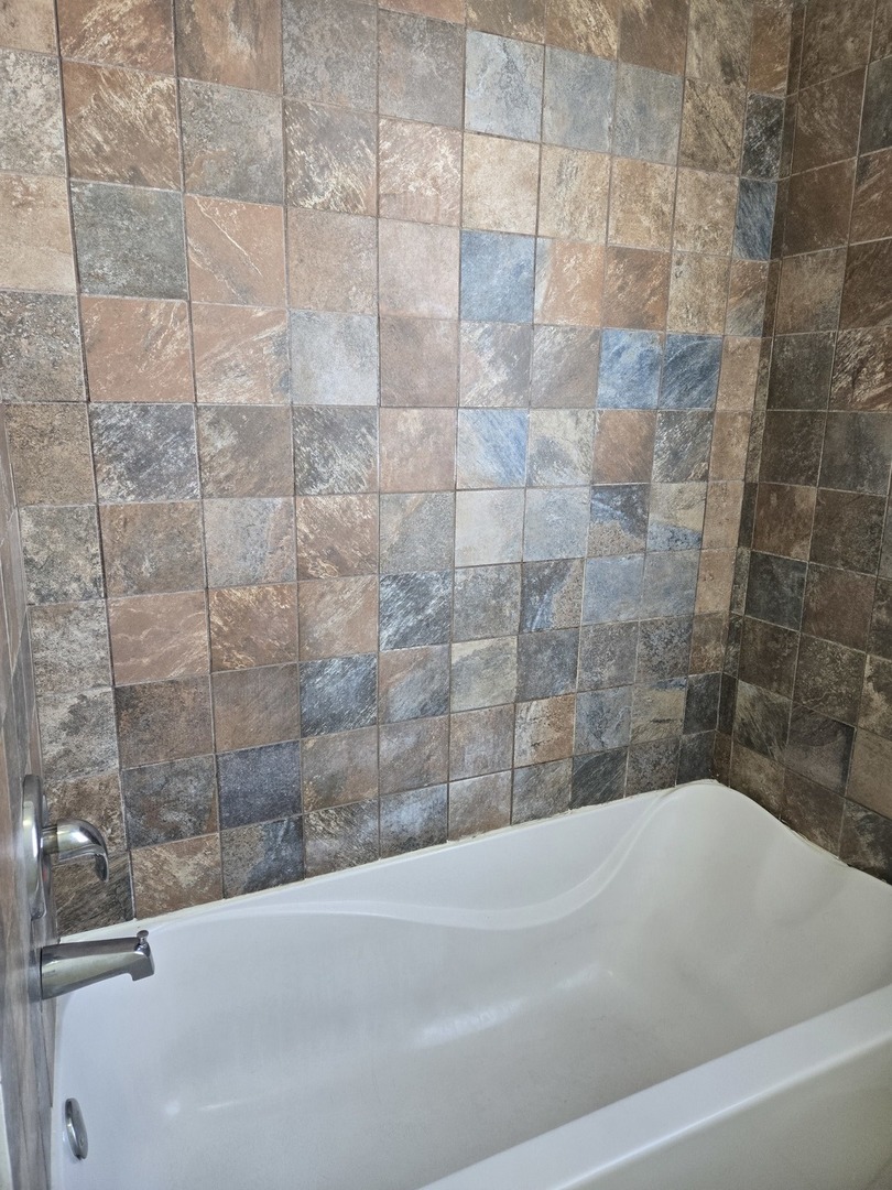 2822 West Marquette Road, Unit 2F Chicago, IL 60629 - Photo 17 of 17 a bathroom with a bathtub